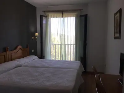 Cama o camas de una habitación en Hotel Cinco Castaños