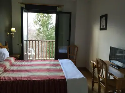Cama o camas de una habitación en Hotel Cinco Castaños