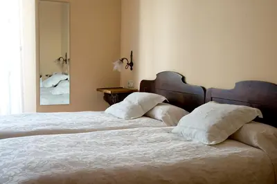 Cama o camas de una habitación en Hotel Don Carlos Cáceres