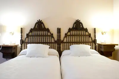 Cama o camas de una habitación en Hotel Don Carlos Cáceres