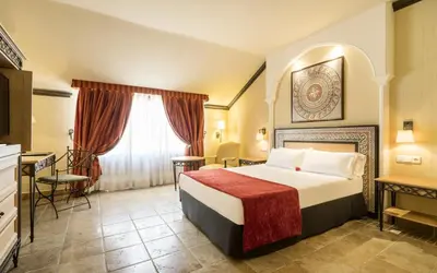 Cama o camas de una habitación en Hotel Ilunion Mérida Palace
