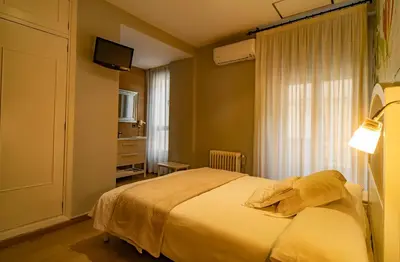 Cama o camas de una habitación en Hotel Alfonso IX
