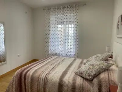 Cama o camas de una habitación en Apartamentos Turísticos LOS BARRUECOS