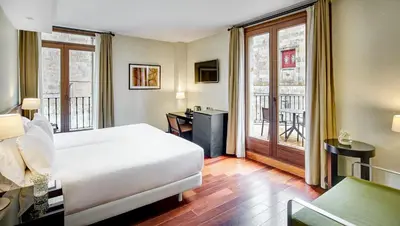 Cama o camas de una habitación en Sercotel Puerta de la Catedral
