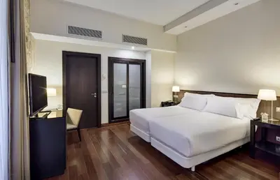 Cama o camas de una habitación en Sercotel Puerta de la Catedral