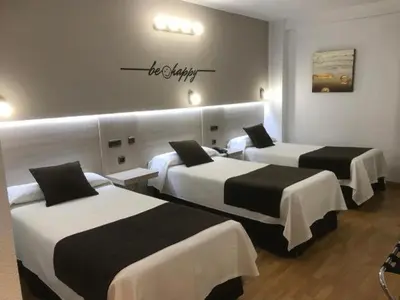 Cama o camas de una habitación en Hotel Mozárbez Salamanca