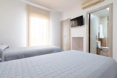 Cama o camas de una habitación en Hostal Viñuela