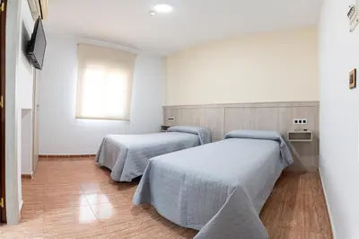 Cama o camas de una habitación en Hostal Viñuela