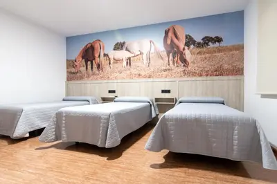 Cama o camas de una habitación en Hostal Viñuela