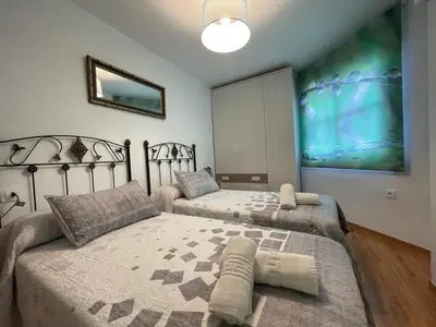 Cama o camas de una habitación en apartamentos MERIDA LÚDICA parking gratis
