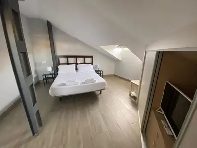 Cama o camas de una habitación en V Apartamento junto a PlazaMayor