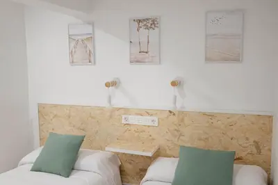 Cama o camas de una habitación en Apartamentos Turísticos A Tu Verita