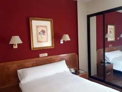 Cama o camas de una habitación en Hotel Don Carmelo